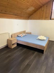 a large bed in a room with a wooden ceiling at Jackys hostel 9 in Sremski Karlovci