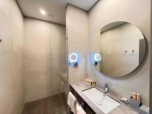 a bathroom with a sink and a mirror at West Plaza Hotel in Oral