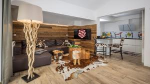 a living room with a couch and a table at Apart AUSTRIA in Finkenberg