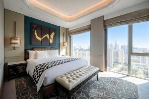 a bedroom with a large bed and a large window at Wanda Reign Chengdu in Chengdu +88 photos
