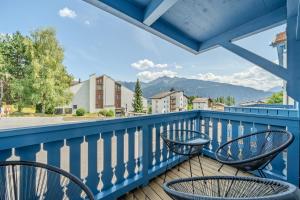 a balcony with chairs and a view of the mountains at Freestyle Alpine Design-Studios - Pool, Parking & Balcony in Center Laax by BlueHills Vacations in Laax