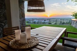 a wooden table with a view of the sunset at Sunset Home in Vršac