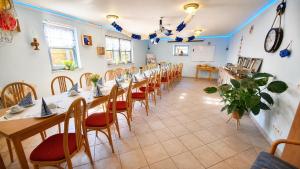 a large room with a long table and chairs at Haus Meeresrauschen in Rerik