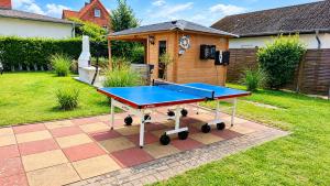 a ping pong table in the backyard of a house at Haus Meeresrauschen in Rerik