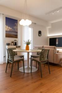 a living room with a table and chairs and a couch at DELL'EDERA Luxury Home in Polignano a Mare