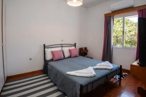 a bedroom with a bed with two towels on it at Chris' Samos Home in Samos +9 photos
