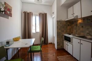a kitchen with a table and a dining room at Chris' Samos Home in Samos