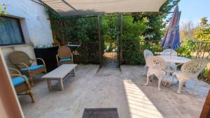 a patio with a table and chairs and an umbrella at Campagne Carbonel in Aix-en-Provence