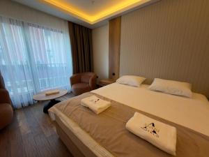 a hotel room with a large bed with towels on it at Alabi Hotels in Istanbul +48 photos