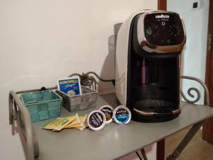 a coffee maker sitting on top of a table at Casa Emma in Cremolino +11 photos