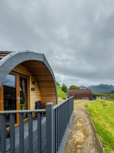 a circular house with a metal arch over a deck at Ben Loyal Hotel in Tongue