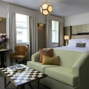 a living room with a couch and a bed at The Academy - Small Luxury Hotels of the World in London