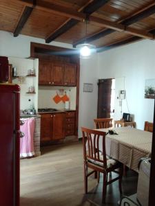 a kitchen with a table and chairs in a room at Casa Emma in Cremolino