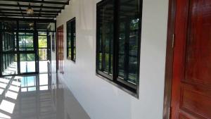 a hallway with a red door and some windows at Lilly Home in Campson