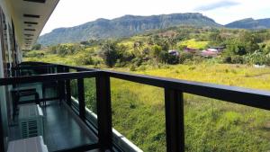 a balcony with a view of a field and mountains at Lilly Home in Campson
