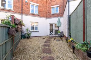 a courtyard of a house with a fence at Sansome House in Worcester