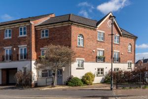 an older brick building with a black roof at Sansome House in Worcester