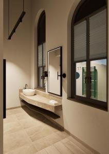 a bathroom with a sink and a mirror at Terra Saar, Weinresort & Spa in Saarburg +13 photos