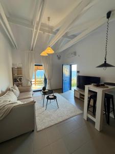 a living room with a couch and a table at Calmora by the Sea in Ancient Epidauros