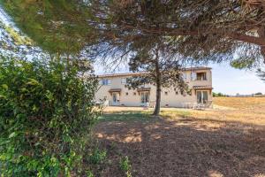 a large white house with a tree in front of it at Duplex N°2 - Résidence Balnéaire in Le Port-des-Barques +15 photos