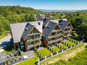 an aerial view of a large house with roofs at Black Mountain Residence & SPA, Odkryj-Białkę in Białka Tatrzańska