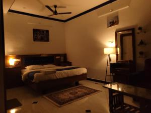 a bedroom with a bed and a ceiling fan at Nivaa Stays - Near JIPMER in Pondicherry