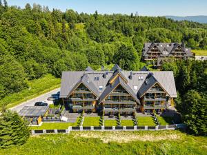 an aerial view of a large log home at Black Mountain Residence & SPA, Odkryj-Białkę in Białka Tatrzańska +77 photos