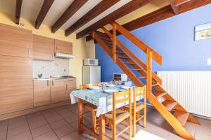 a kitchen with a table and a staircase in a room at Duplex N°5 - Résidence Balnéaire in Le Port-des-Barques