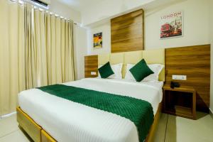 a bedroom with a large bed in a room at The Heartland Business Hotel in Trivandrum +39 photos