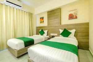 two beds in a hotel room at The Heartland Business Hotel in Trivandrum