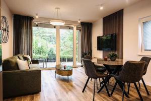 a living room with a table and a couch at R&J apartmány in Bojnice +16 photos