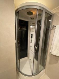 a shower with a glass door in a bathroom at Hotel Heranya in Kathmandu