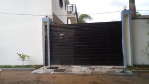 a gate to a house with a fence at Villa TSARAJORO in Toamasina
