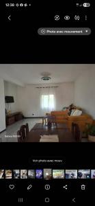 a picture of a room with a table and a couch at Villa TSARAJORO in Toamasina