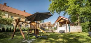 a playground with an umbrella and a slide at Ubytování pod Dubem in Broumov