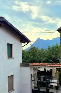a white house with a view of the mountain at La Tana del Ghiro in Condove