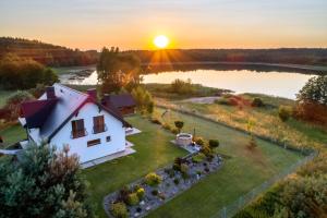 an aerial view of a house with a lake at Siedlisko Rogówko in Rogówko