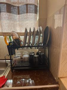 a shelf filled with utensils in a kitchen at Sunrise Suites EMBU in Embu