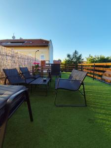 a group of chairs and tables on a patio at Apartman Aurora in Slavonski Brod