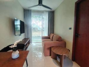 a living room with a couch and a table at Syama Mansion Kamala in Kamala Beach +13 photos