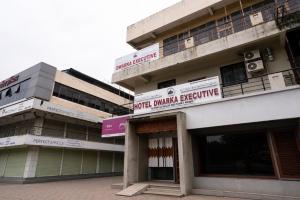 a building with signs on the side of it at Hotel Dwarka Executive in Nashik