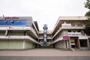 an external view of a building with a courtyard at Hotel Dwarka Executive in Nashik