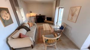 a living room with a couch and chairs and a table at Urla Sunrise House in Ildır