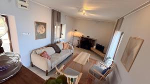 a living room with a couch and a fireplace at Urla Sunrise House in Ildır