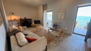 a living room with a couch and a table at Urla Sunrise House in Ildır
