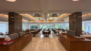a dining room with tables and chairs and windows at Hotel João Paulo II in Braga