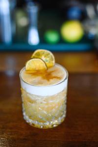 a drink with a lemon slice on a table at Pongwe Beach Hotel in Pongwe