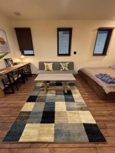 a living room with a couch and a table at WAAP Hotel in Ishigaki Island