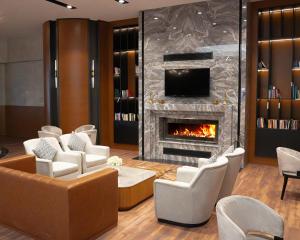 a lobby with chairs and a fireplace at Tripolis Hotel in Pamukkale