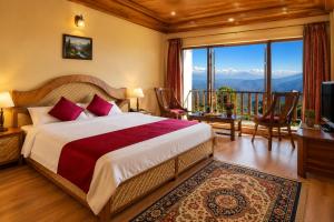 a bedroom with a bed and a balcony with mountains at Swaasha Vista in Kausani